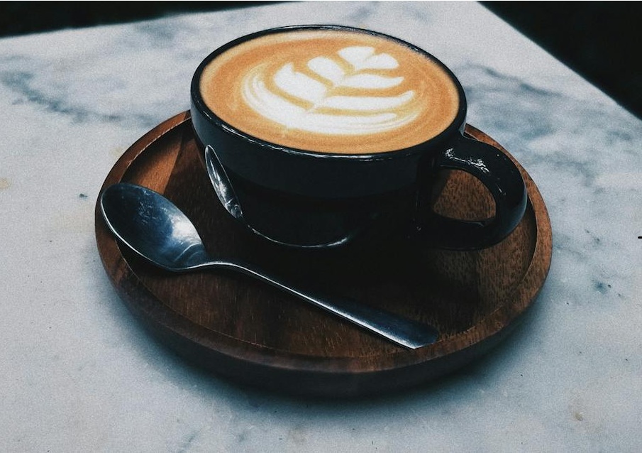 A freshly brewed latte on a marble table